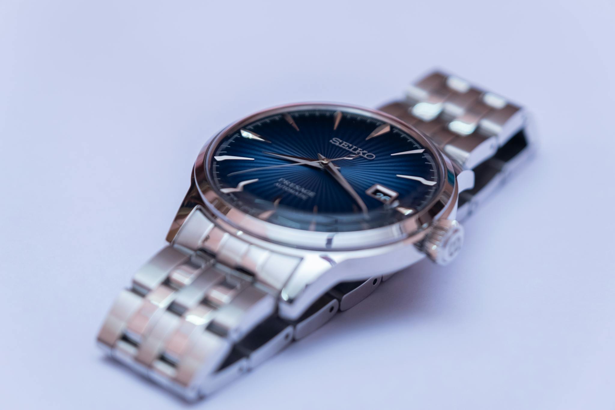 Detailed shot of a Seiko wristwatch with a metallic band, perfect for timepiece enthusiasts and accessory lovers.
