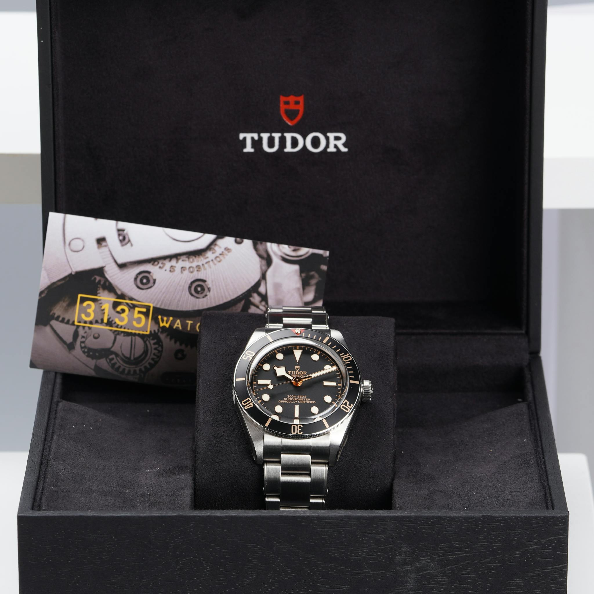 Elegant Tudor wristwatch showcased in a luxurious black velvet box, exuding sophistication and style.